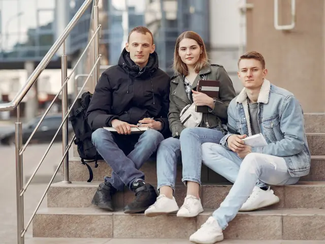 International students sitting together on campus steps